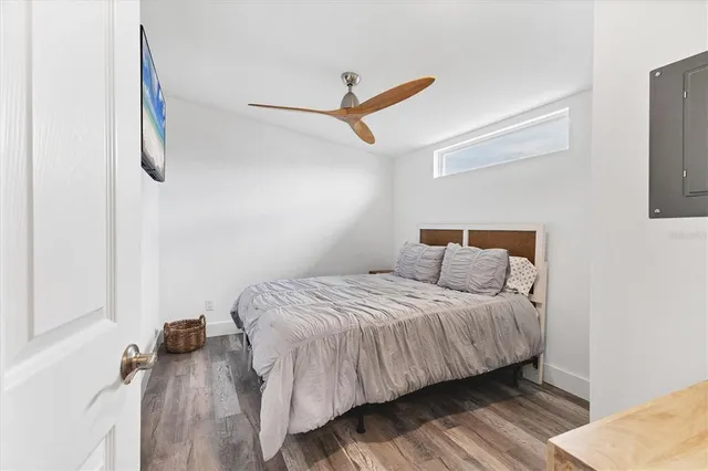 a bedroom with a bed and flat screen tv