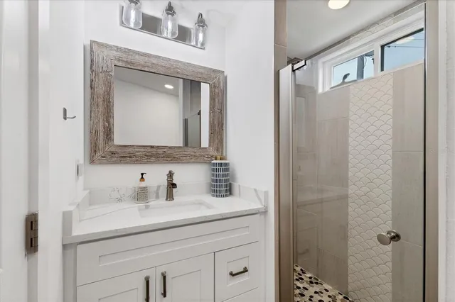 a bathroom with a sink vanity and a mirror