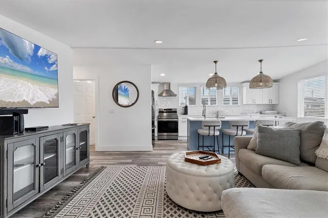 a living room with furniture a rug and a fireplace