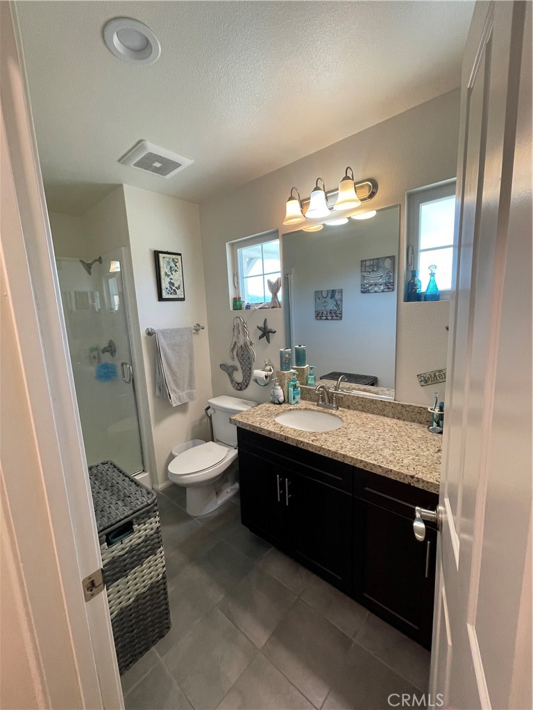 110 Main Street Piru, CA 93040 - Photo 12 of 15 a spacious bathroom with a granite countertop sink and a mirror
