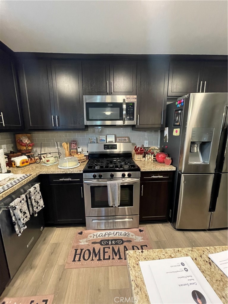 110 Main Street Piru, CA 93040 - Photo 3 of 15 a kitchen with granite countertop stainless steel appliances and a sink