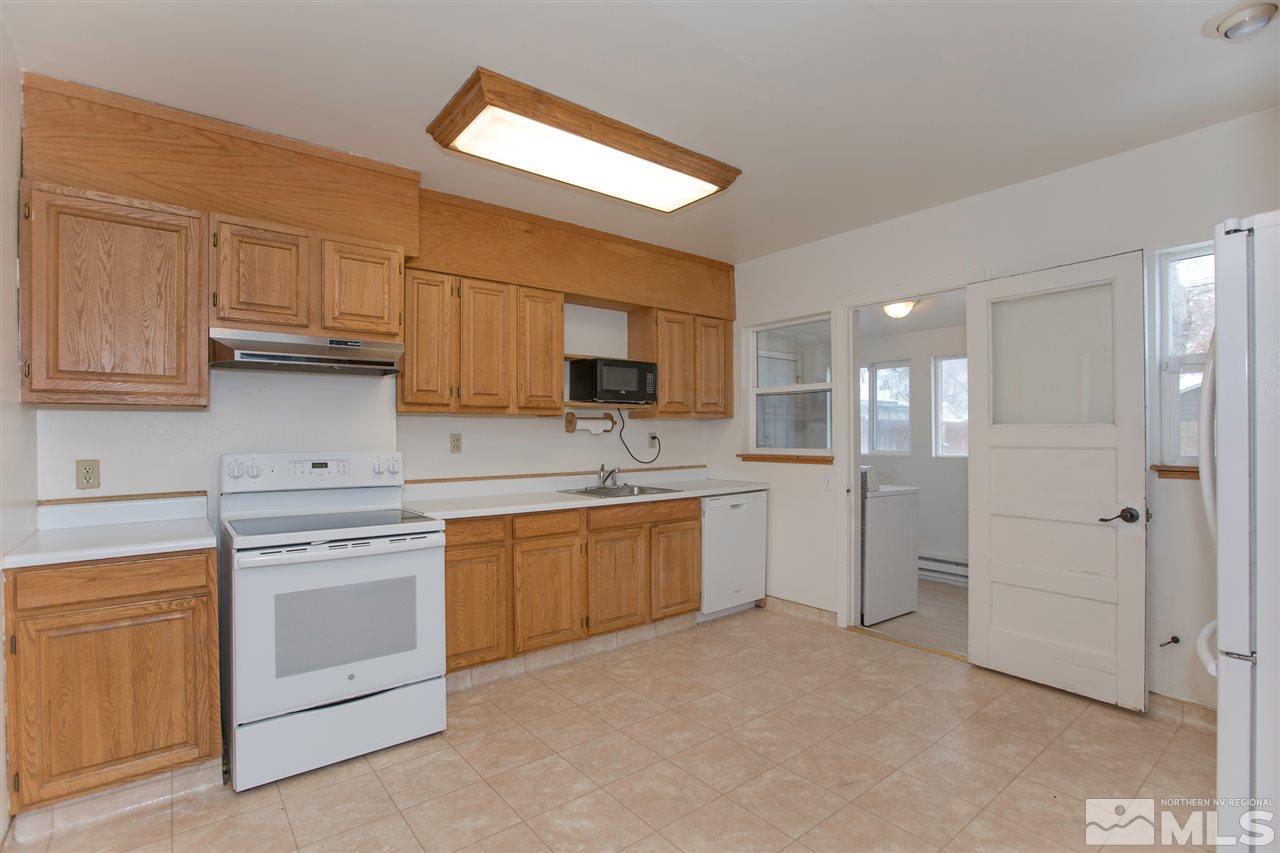 725 Balzar Circle Reno, NV 89502 - Photo 12 of 22 a kitchen with white cabinets and white appliances
