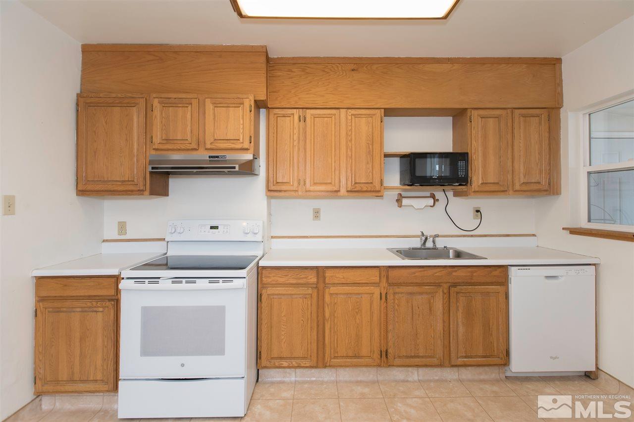 725 Balzar Circle Reno, NV 89502 - Photo 13 of 22 a kitchen with a sink stove and cabinets