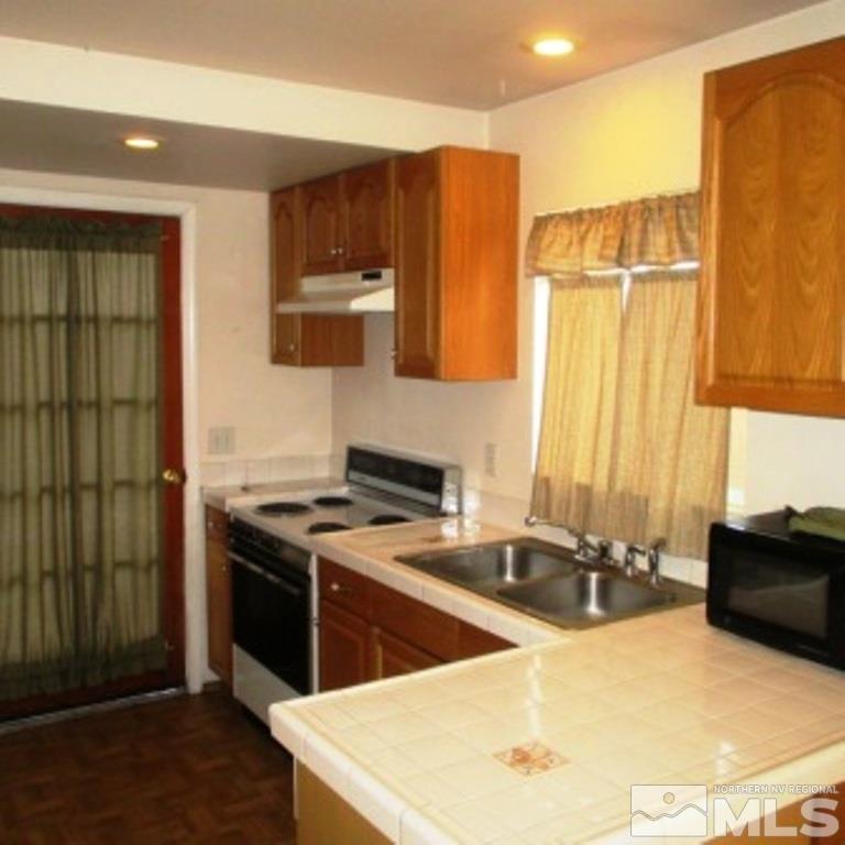 725 Balzar Circle Reno, NV 89502 - Photo 19 of 22 a kitchen with a sink a stove and a refrigerator