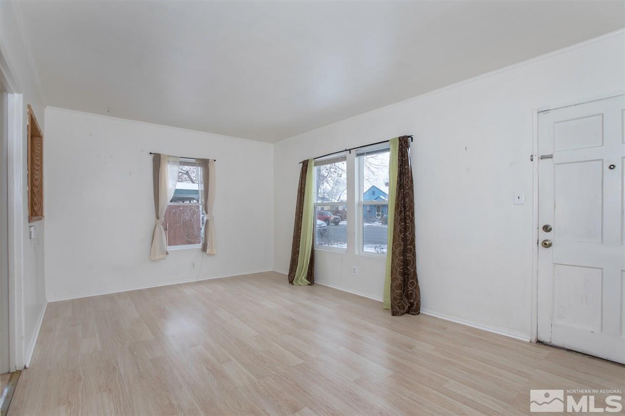 725 Balzar Circle Reno, NV 89502 - Photo 8 of 22 an empty room with wooden floor and windows