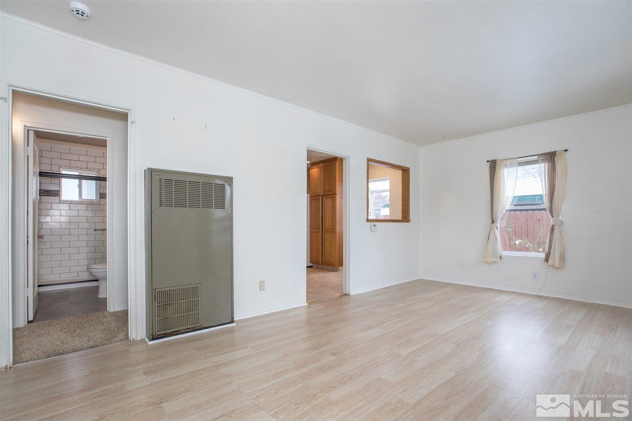 725 Balzar Circle Reno, NV 89502 - Photo 9 of 22 a view of an empty room with wooden floor and a window