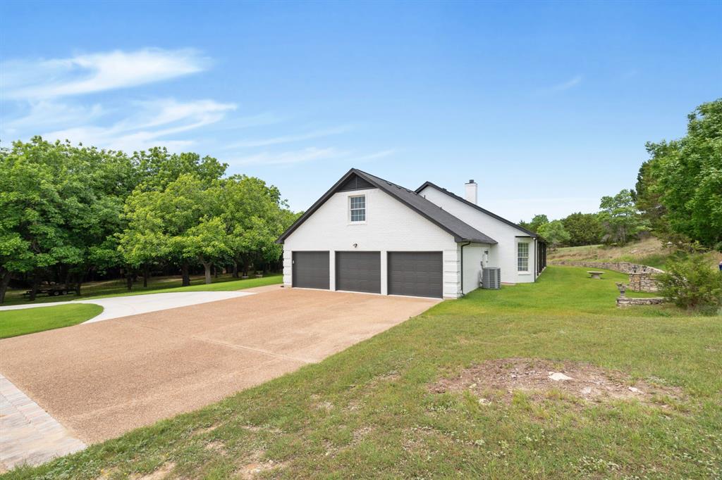 72 Crown Road Willow Park, TX 76087 - Photo 5 of 40 a view of a house with yard and garage