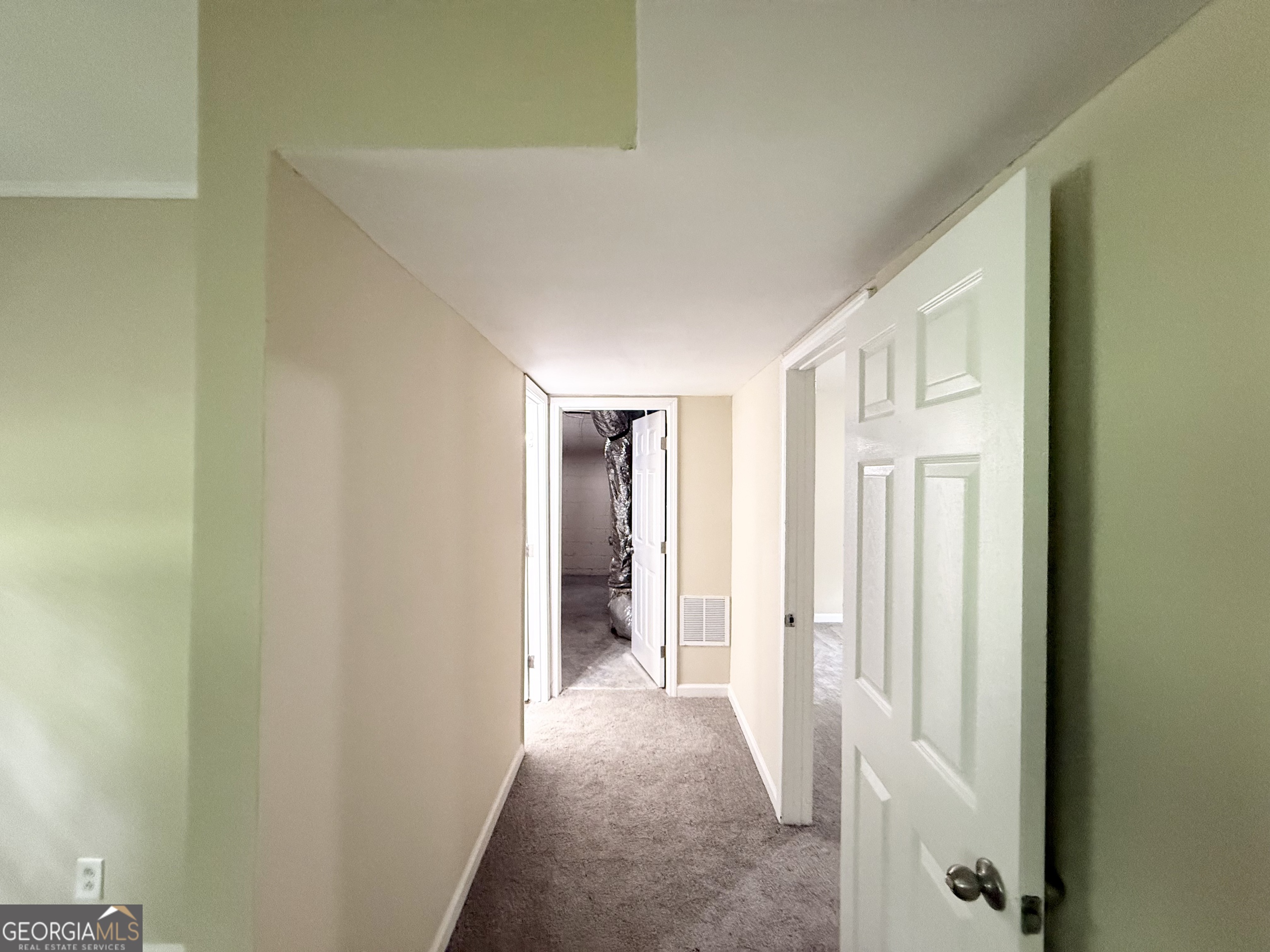 2782 Ocean Valley Road Atlanta, GA 30349 - Photo 21 of 27 a view of a hallway with wooden shelves