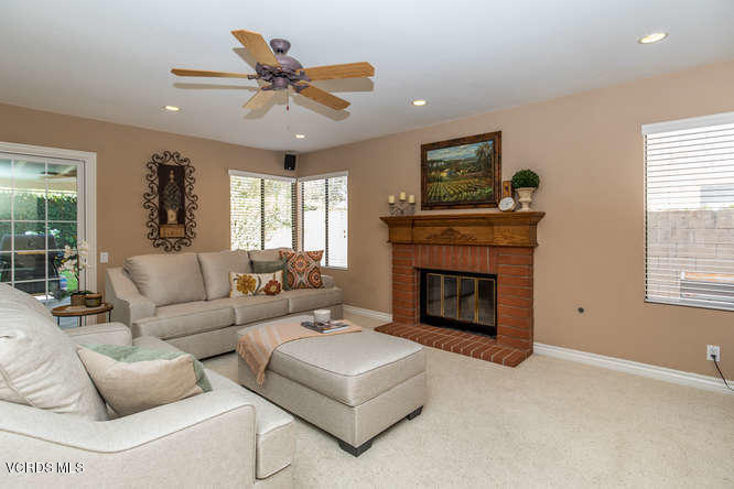 12440 Crystal Ranch Road Moorpark, CA 93021 - Photo 11 of 51 a living room with furniture a fireplace and a large window
