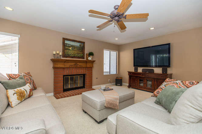 12440 Crystal Ranch Road Moorpark, CA 93021 - Photo 12 of 51 a living room with furniture a flat screen tv and a fireplace