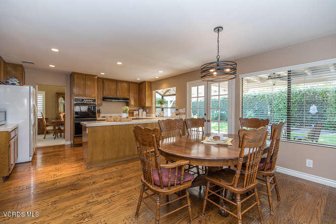 12440 Crystal Ranch Road Moorpark, CA 93021 - Photo 14 of 51 a dining room with furniture a chandelier and wooden floor