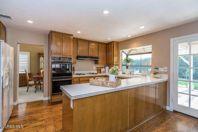 12440 Crystal Ranch Road Moorpark, CA 93021 - Photo 18 of 51 a kitchen with stainless steel appliances granite countertop a sink a stove and refrigerator