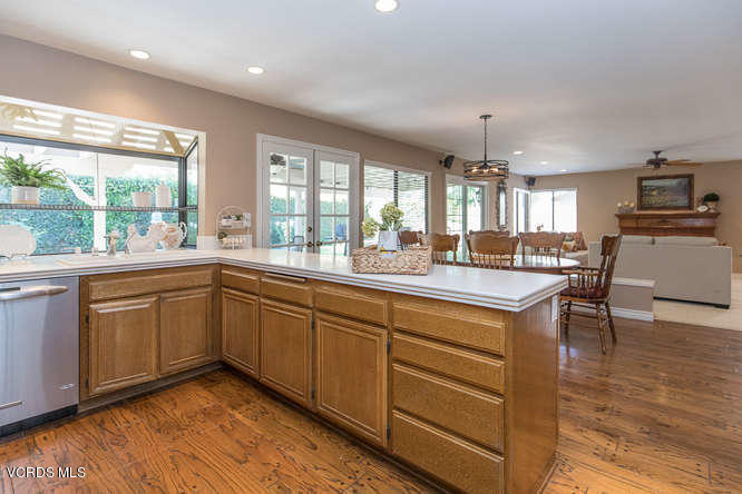 12440 Crystal Ranch Road Moorpark, CA 93021 - Photo 23 of 51 a kitchen with stainless steel appliances granite countertop wooden floors and white cabinets