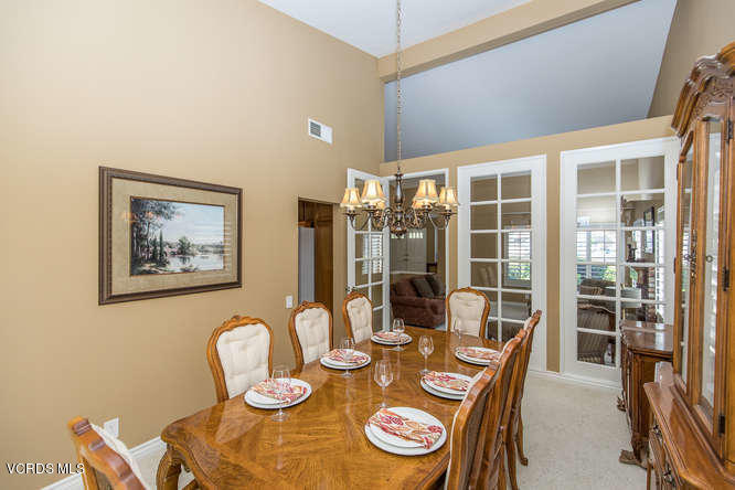 12440 Crystal Ranch Road Moorpark, CA 93021 - Photo 10 of 51 a dining room with furniture a kitchen view and a chandelier