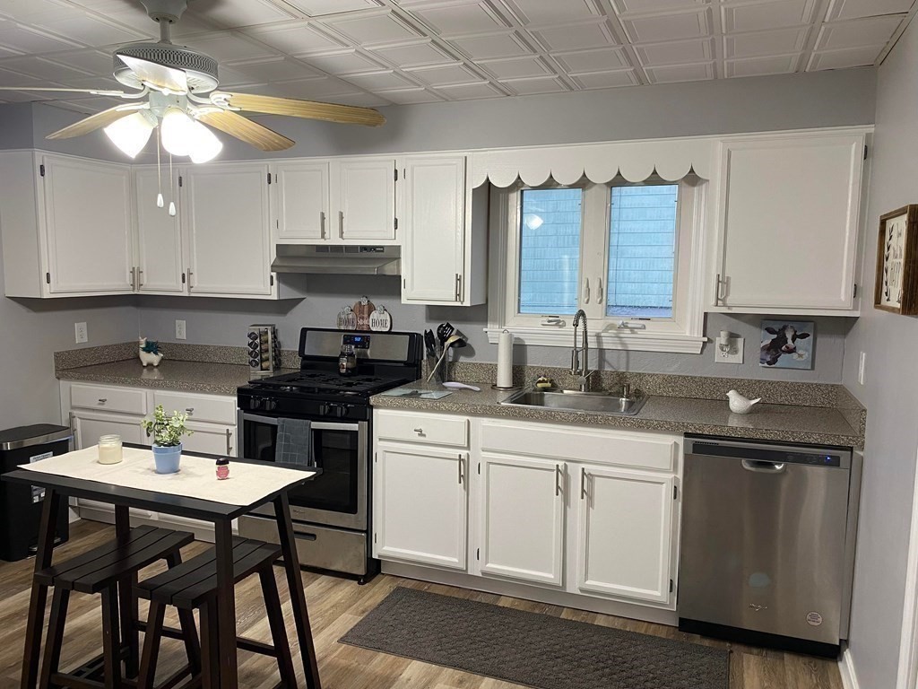 77 Carter Street Fall River, MA 02721 - Photo 1 of 25 a kitchen with a white cabinets and chairs