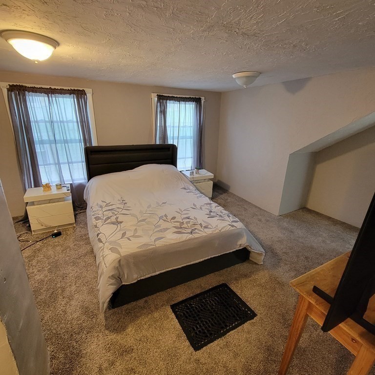 77 Carter Street Fall River, MA 02721 - Photo 21 of 25 a bedroom with a bed and window