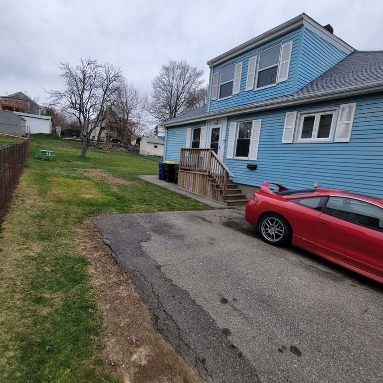 77 Carter Street Fall River, MA 02721 - Photo 3 of 25 a car parked in front of a house with a yard