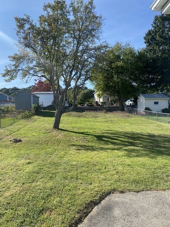 77 Carter Street Fall River, MA 02721 - Photo 6 of 25 a view of a yard with a house in the background
