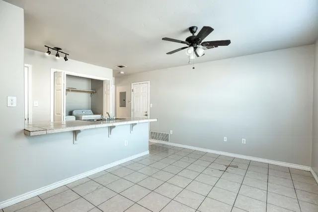 a view of a kitchen with a sink stainless steel appliances and cabinets
