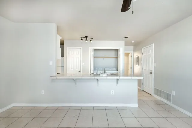 a kitchen with white cabinets