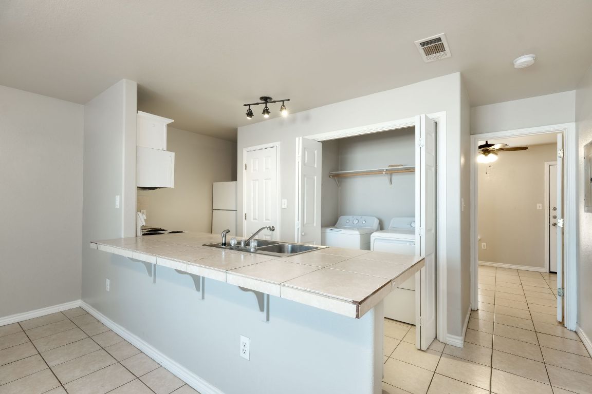 107 Castleberry Court, Unit B Bertram, TX 78605 - Photo 7 of 15 a room with a sink and cabinets