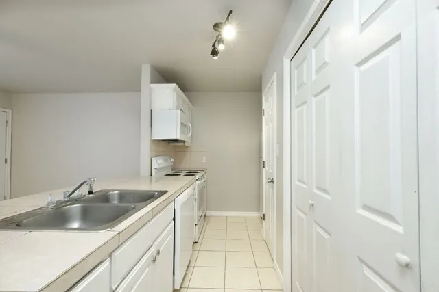 a kitchen with a sink and cabinets