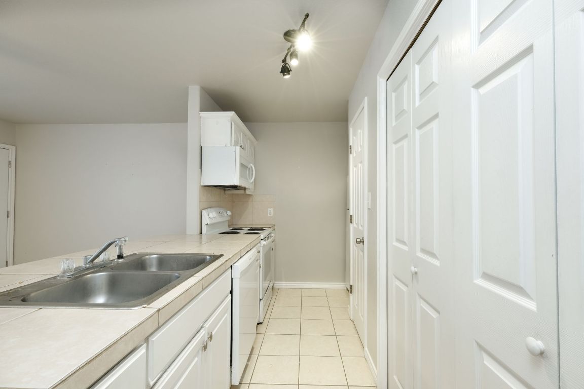 107 Castleberry Court, Unit B Bertram, TX 78605 - Photo 8 of 15 a kitchen with a sink and cabinets