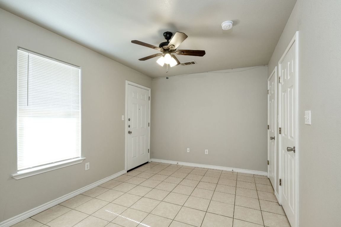 107 Castleberry Court, Unit B Bertram, TX 78605 - Photo 10 of 15 a view of an empty room and window chandelier fan