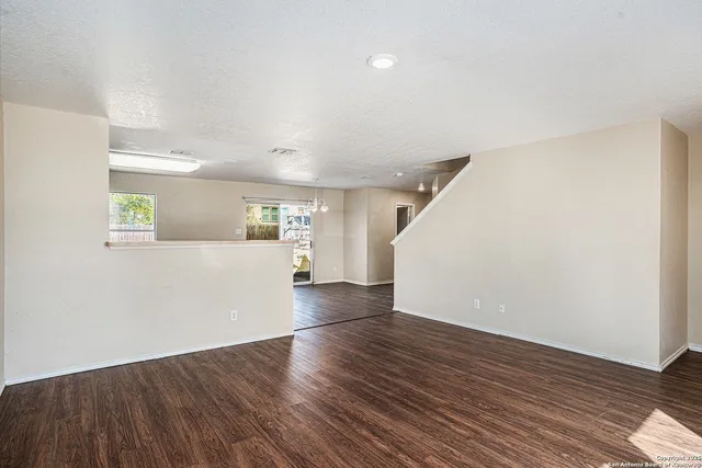 a view of a kitchen with wooden floor and a ceiling fan