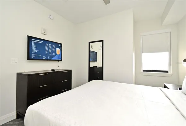 a bedroom with a bed and a window