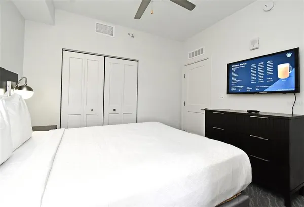 a bedroom with a bed and a dresser
