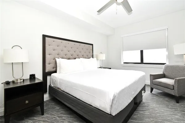 a bedroom with bed and window