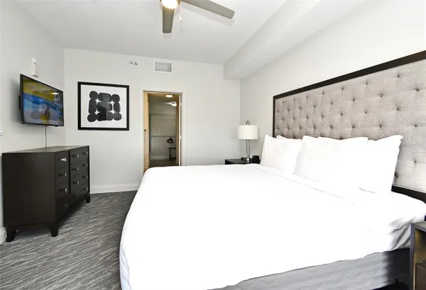 a bedroom with a bed and a flat screen tv