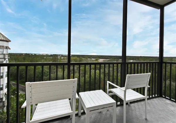 a view of a balcony with furniture