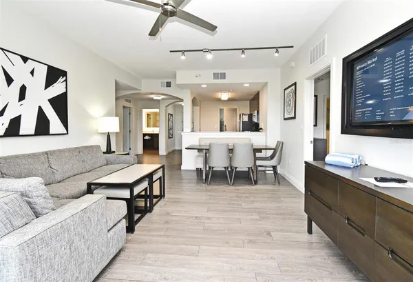 a living room with furniture kitchen view and a table