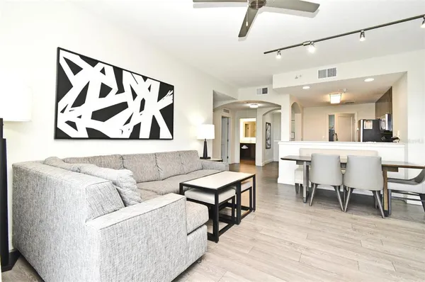 a living room with furniture and wooden floor