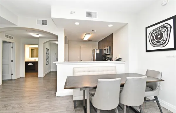 a view of a dining room with furniture and wooden floor
