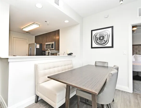 a view of a dining room with furniture and wooden floor