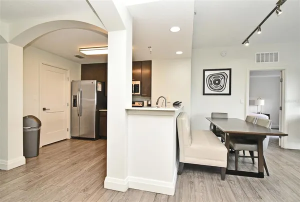 a view of a kitchen area with furniture and wooden floor