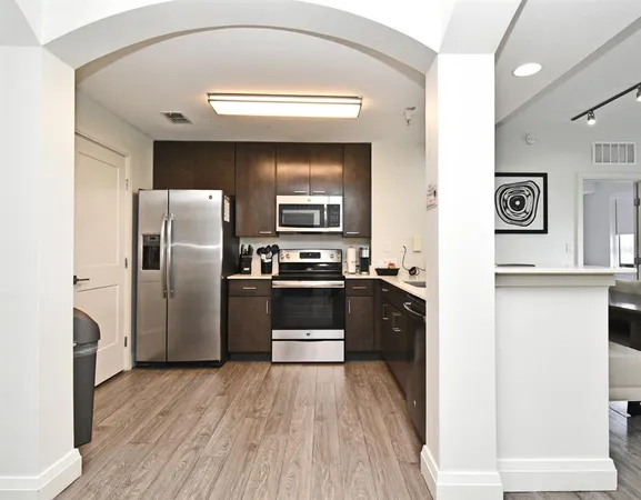 a kitchen with a refrigerator and a stove