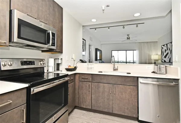 a kitchen with a sink stove and microwave