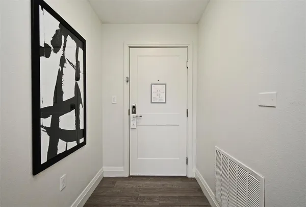 a view of an entryway with wooden floor