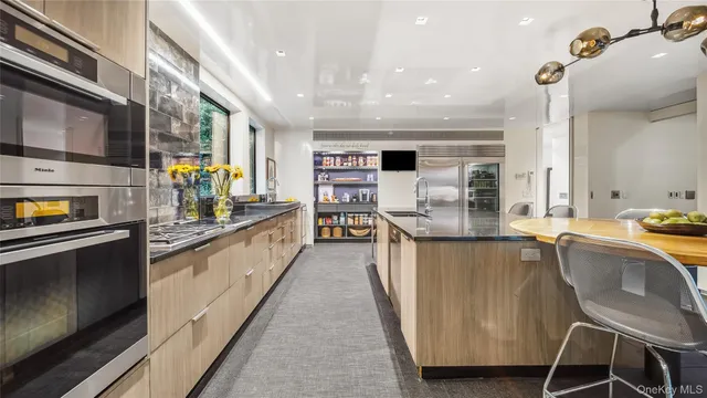 a kitchen with a table chairs stove and refrigerator