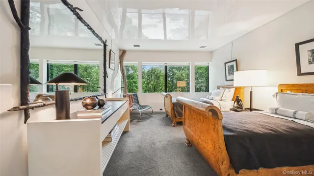 a bed sitting in a bedroom next to a window