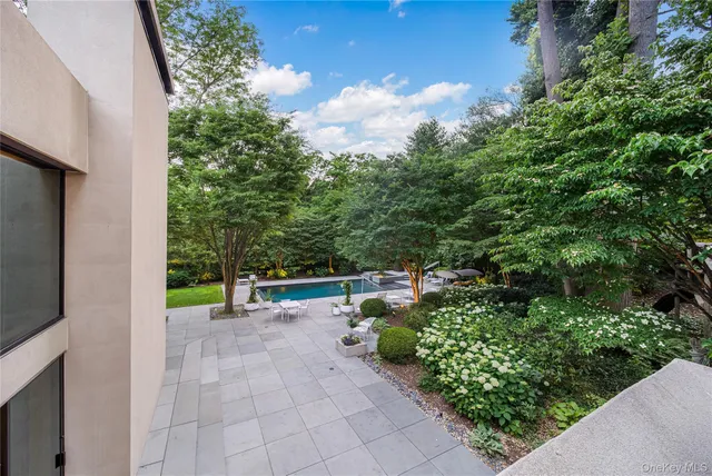 a front view of a house with yard and green space