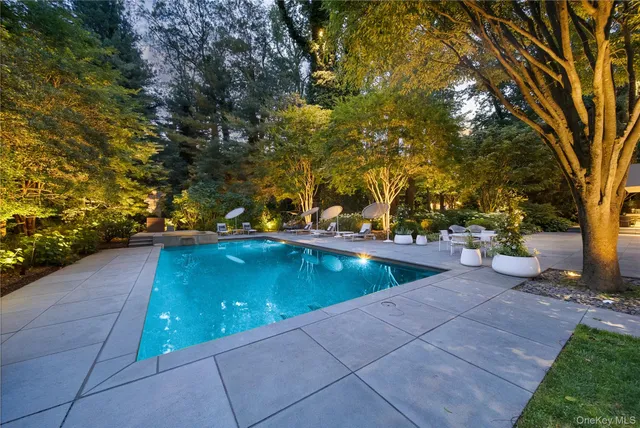 an aerial view of a house with a yard and large tree