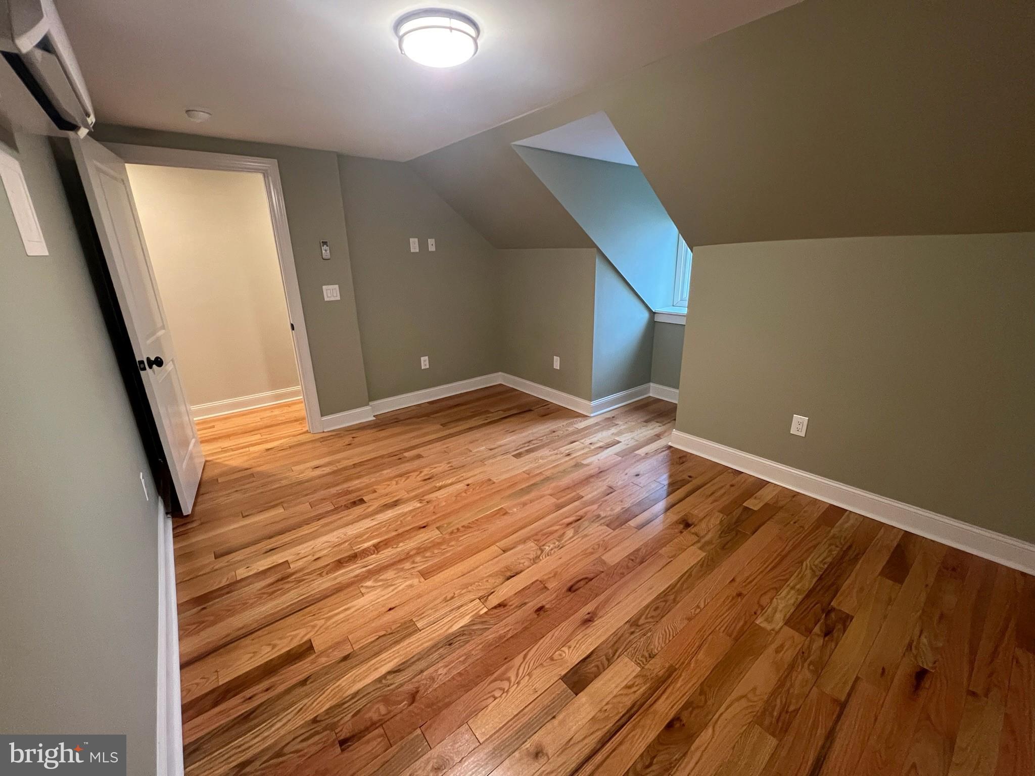 235 Pine Street Philadelphia, PA 19106 - Photo 13 of 18 a view of an empty room with wooden floor and a window