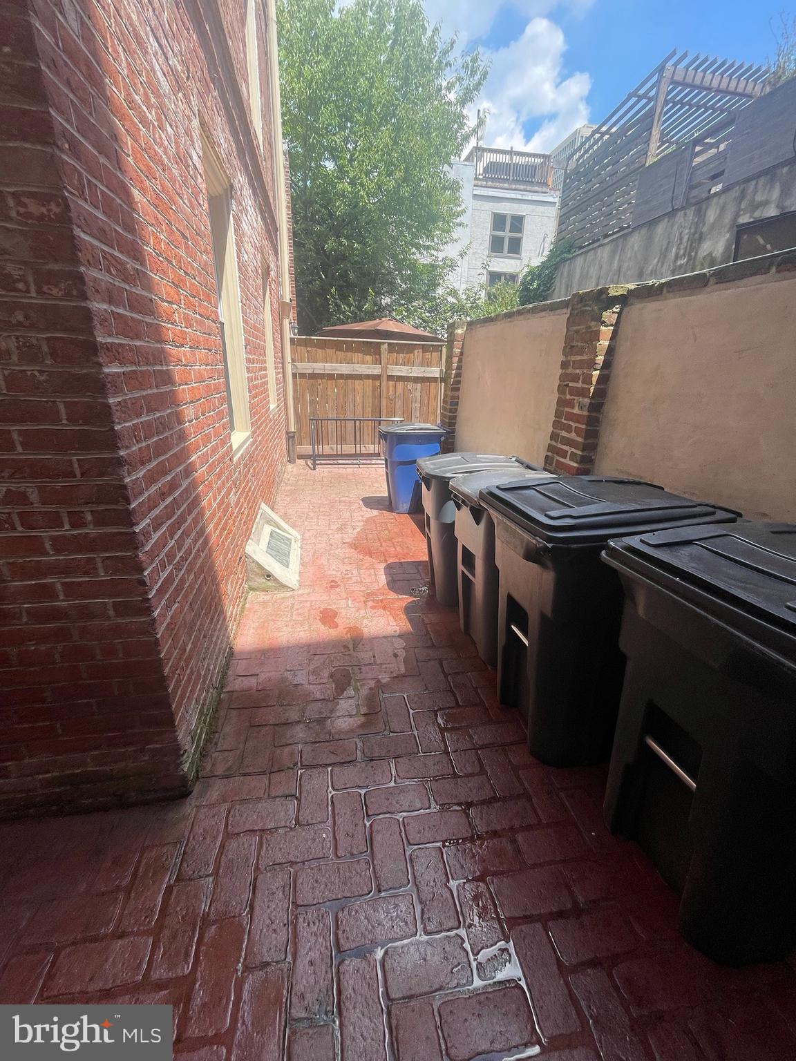 235 Pine Street Philadelphia, PA 19106 - Photo 2 of 18 a view of a patio with table and chairs with wooden floor and fence
