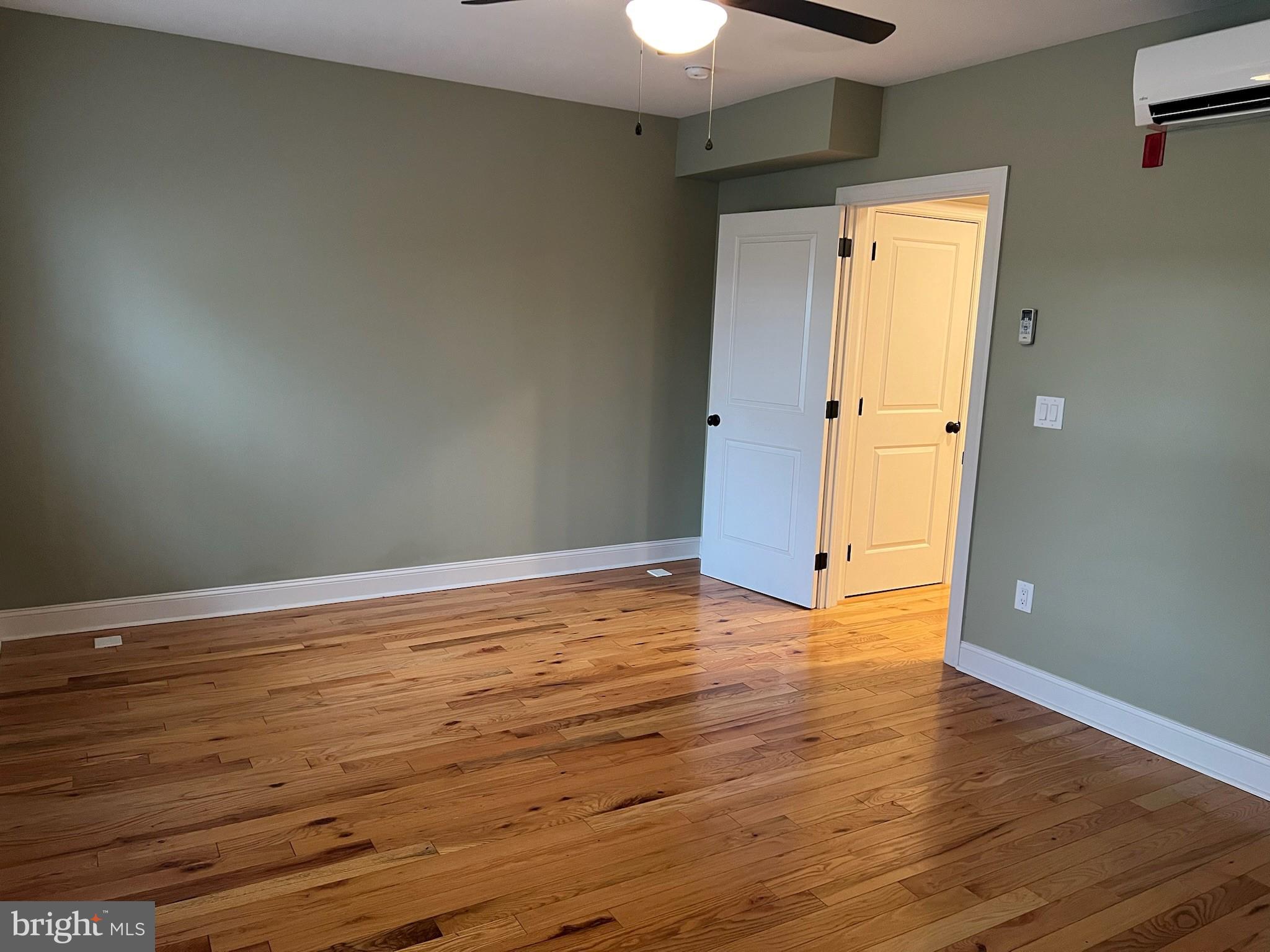 235 Pine Street Philadelphia, PA 19106 - Photo 9 of 18 a view of an empty room with wooden floor and a window