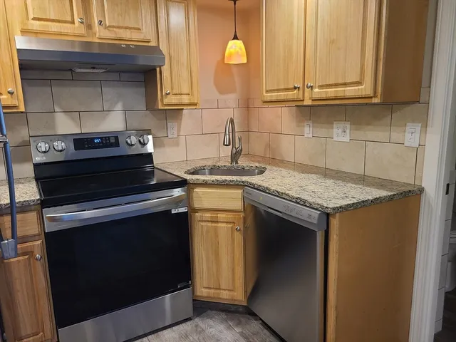a kitchen with a stove and a sink